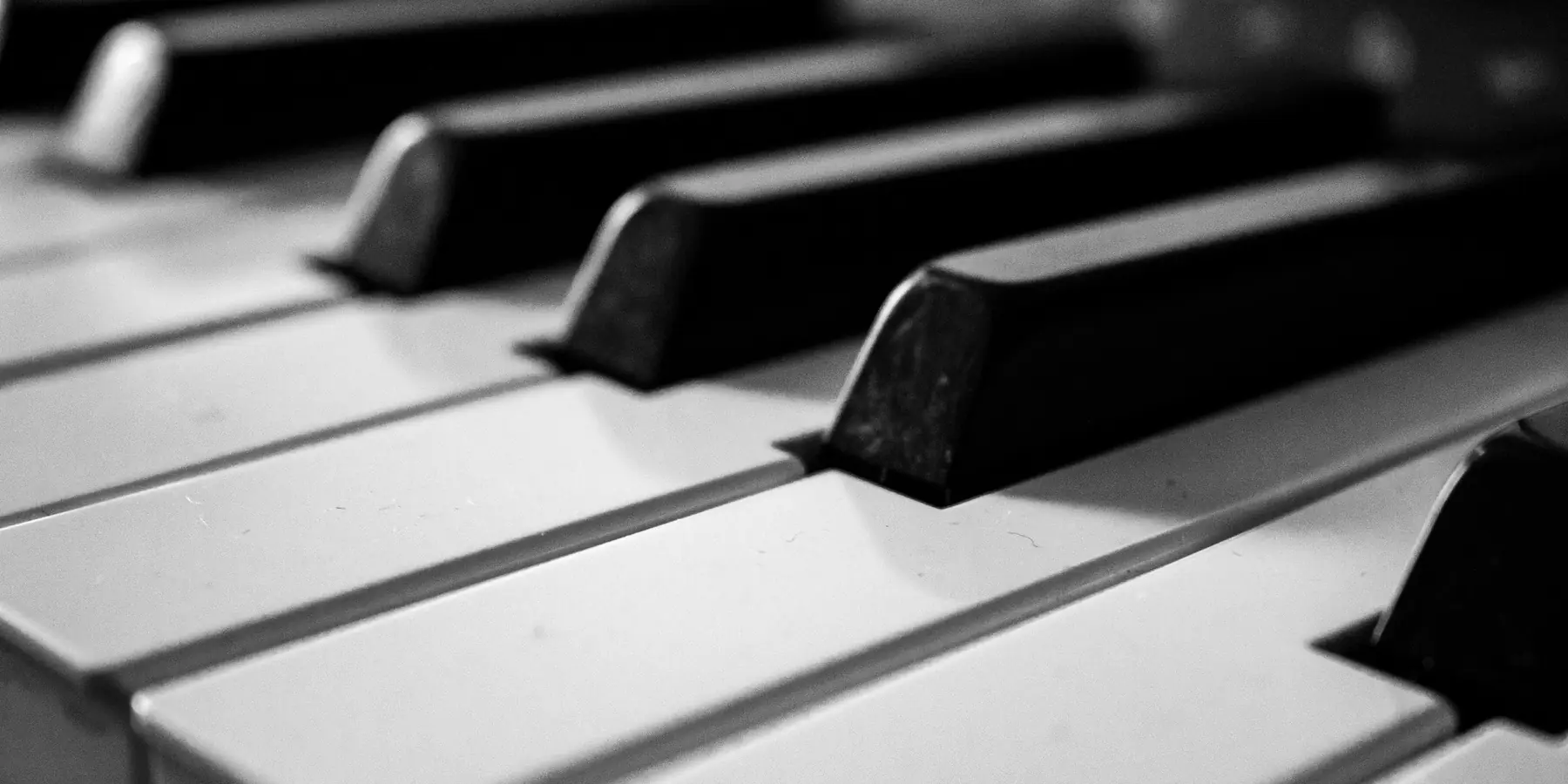 Close-up of white and black piano keys seen at a low angle